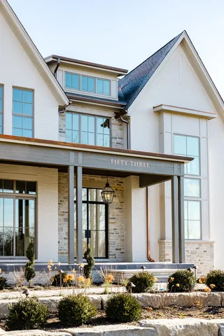 a front view of a house with lots of windows