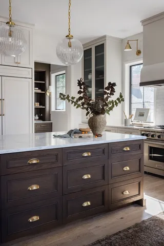 a bathroom with a granite countertop double vanity sink and stove