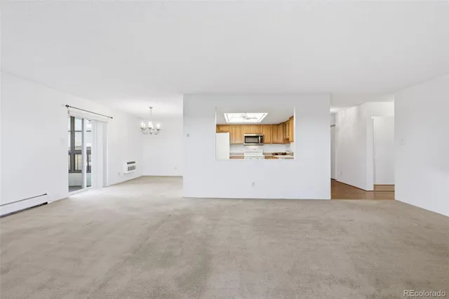 a view of a livingroom with wooden floor and a ceiling fan