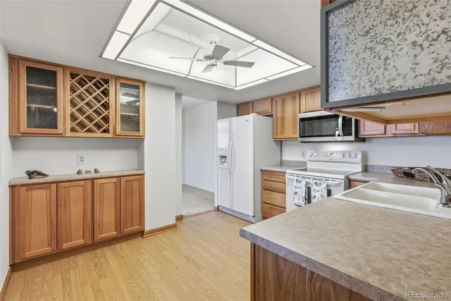 a kitchen with stainless steel appliances granite countertop a wooden cabinets a stove top oven a sink and dishwasher