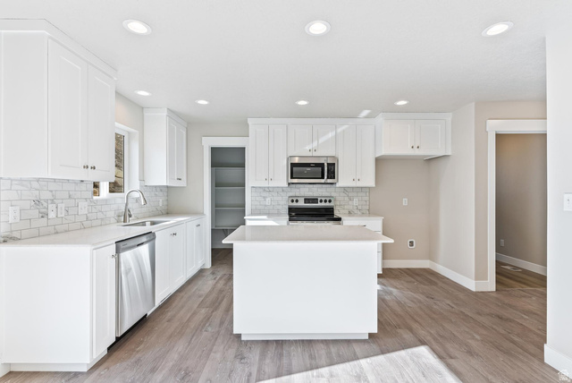 257 North Slant Road, Unit 51M Mapleton, UT 84660 - Photo 6 of 24 Kitchen featuring white cabinets, stainless steel appliances, recessed lighting, light wood-style flooring, and tasteful backsplash