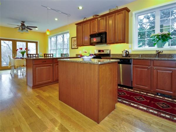 75 Ridgeway Avenue Needham, MA 02492 - Photo 7 of 22 a kitchen with stainless steel appliances granite countertop a stove a sink and a microwave