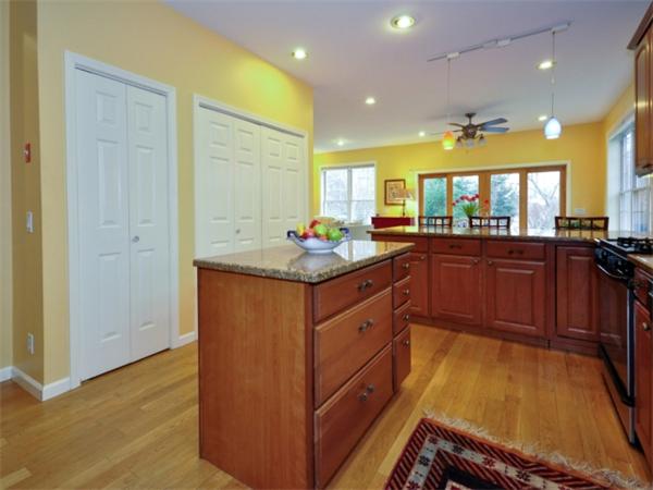 75 Ridgeway Avenue Needham, MA 02492 - Photo 8 of 22 a kitchen with kitchen island granite countertop wooden cabinets a sink and a stove
