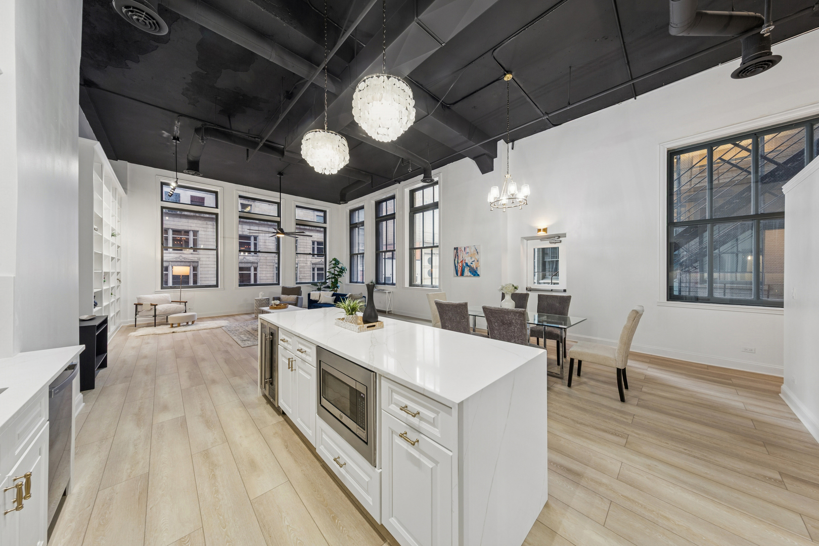 120 South State Street, Unit 4 Chicago, IL 60603 - Photo 11 of 28 a large white kitchen with a large window a counter space and stainless steel appliances