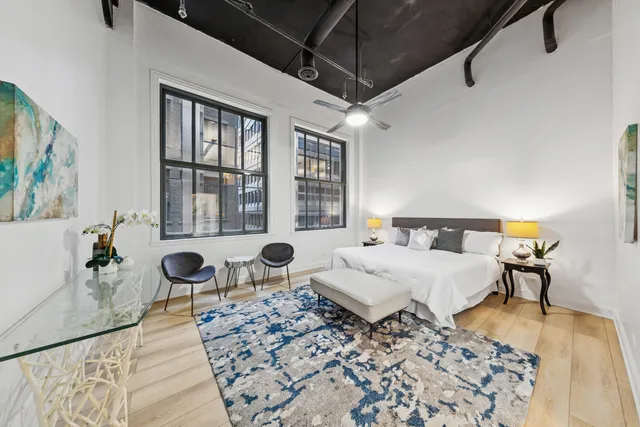 a bedroom with a bed and a couch