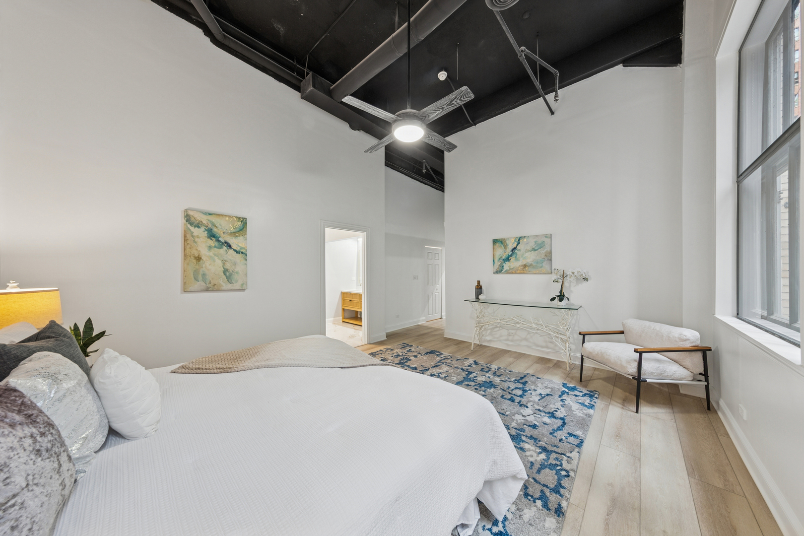 120 South State Street, Unit 4 Chicago, IL 60603 - Photo 13 of 28 a bedroom with a bed and a couch