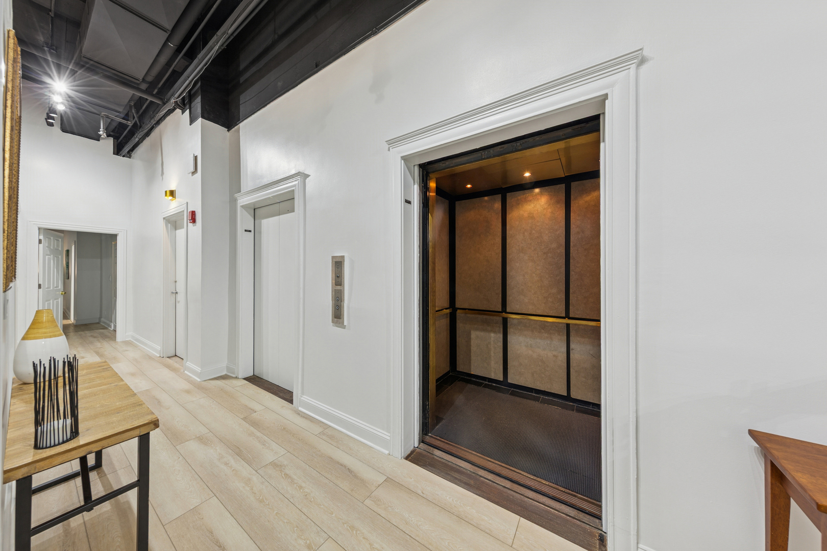 120 South State Street, Unit 4 Chicago, IL 60603 - Photo 2 of 28 a view of a hallway with wooden floor and staircase