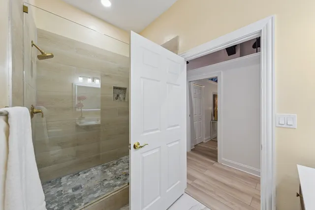 a view of hallway with wooden floor