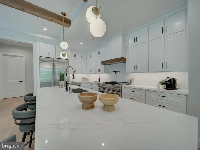 a living room with furniture fireplace and a large window