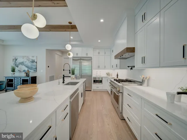 a living room with furniture and view of kitchen