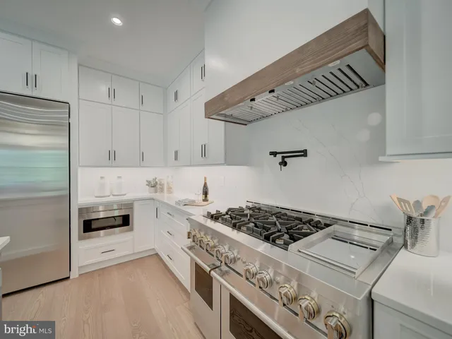 a spacious bathroom with a bathtub shower sink mirror and toilet