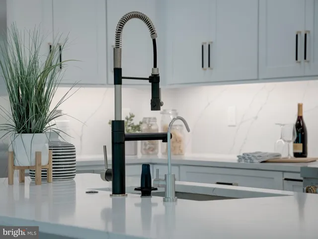 a living room with furniture a window and a potted plant