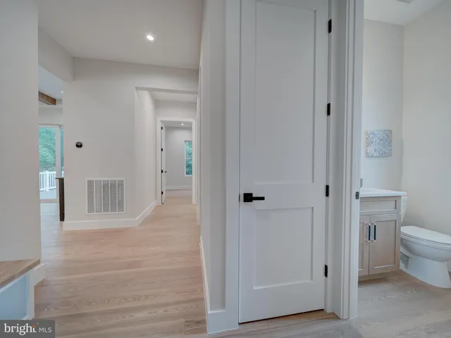 a spacious bedroom with a bed and a chandelier