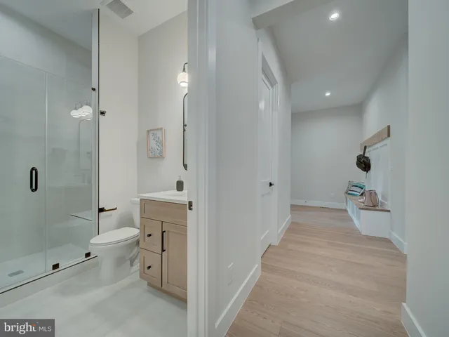 a view of a hallway with wooden shelves