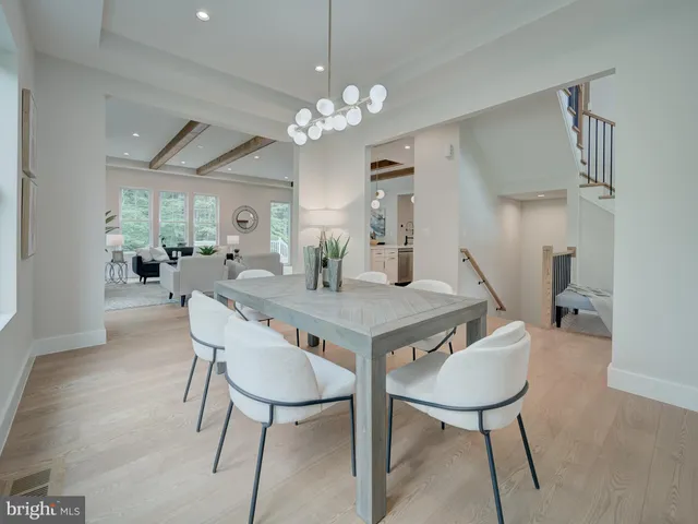 a large white kitchen with lots of counter space a sink a window and stainless steel appliances