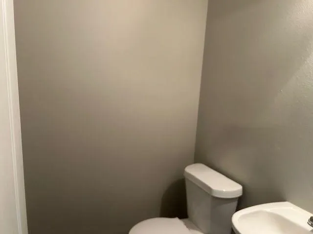 a white toilet and tub next to a bathroom sink