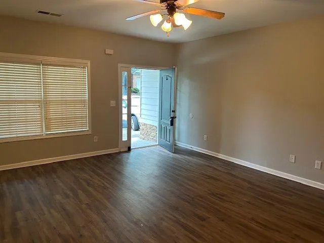a kitchen with granite countertop a refrigerator and a stove top oven