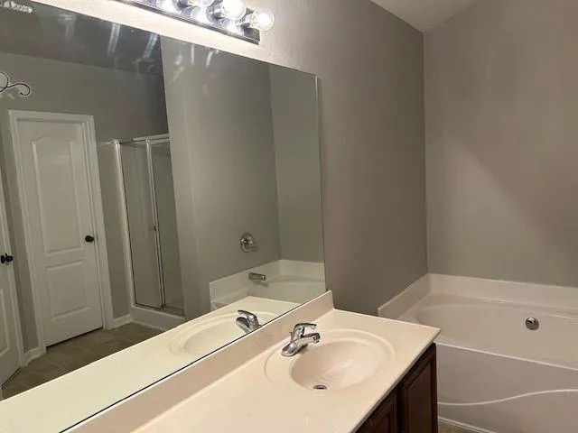 a bathroom with a shower and a sink