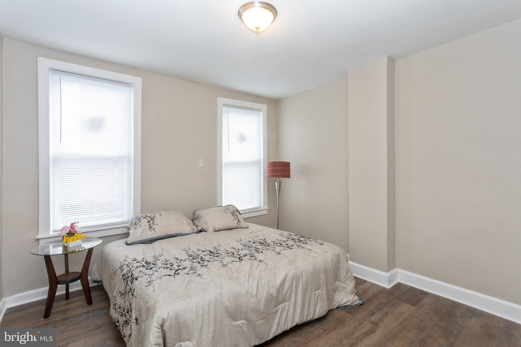 3988 Roland Avenue Baltimore, MD 21211 - Photo 18 of 31 a bedroom with a bed and wooden floor
