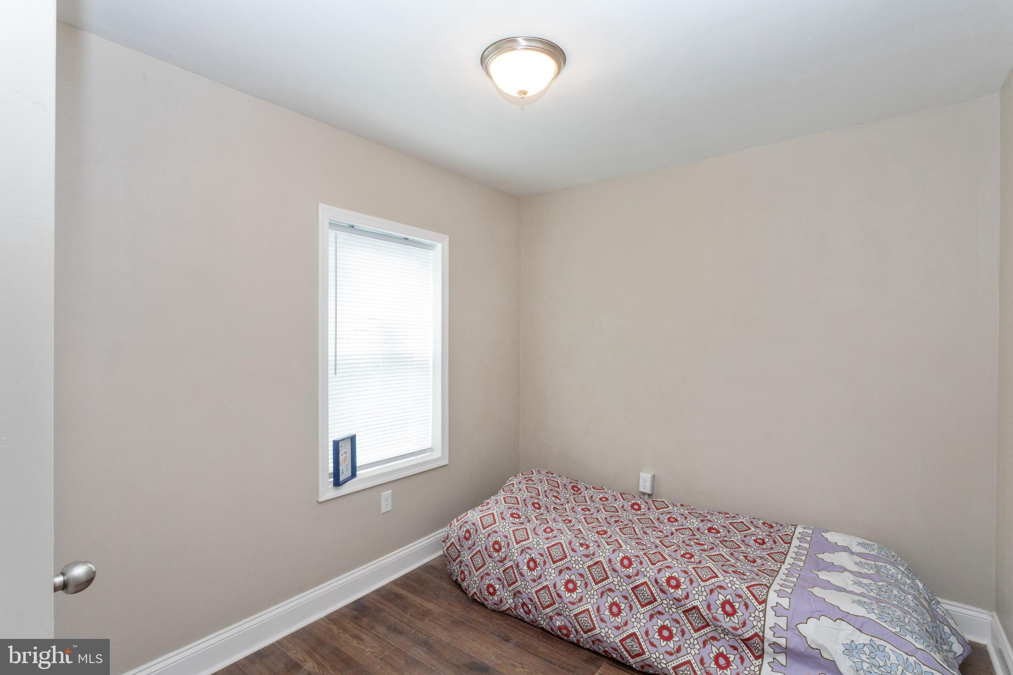 3988 Roland Avenue Baltimore, MD 21211 - Photo 23 of 31 a bedroom with a bed and a window