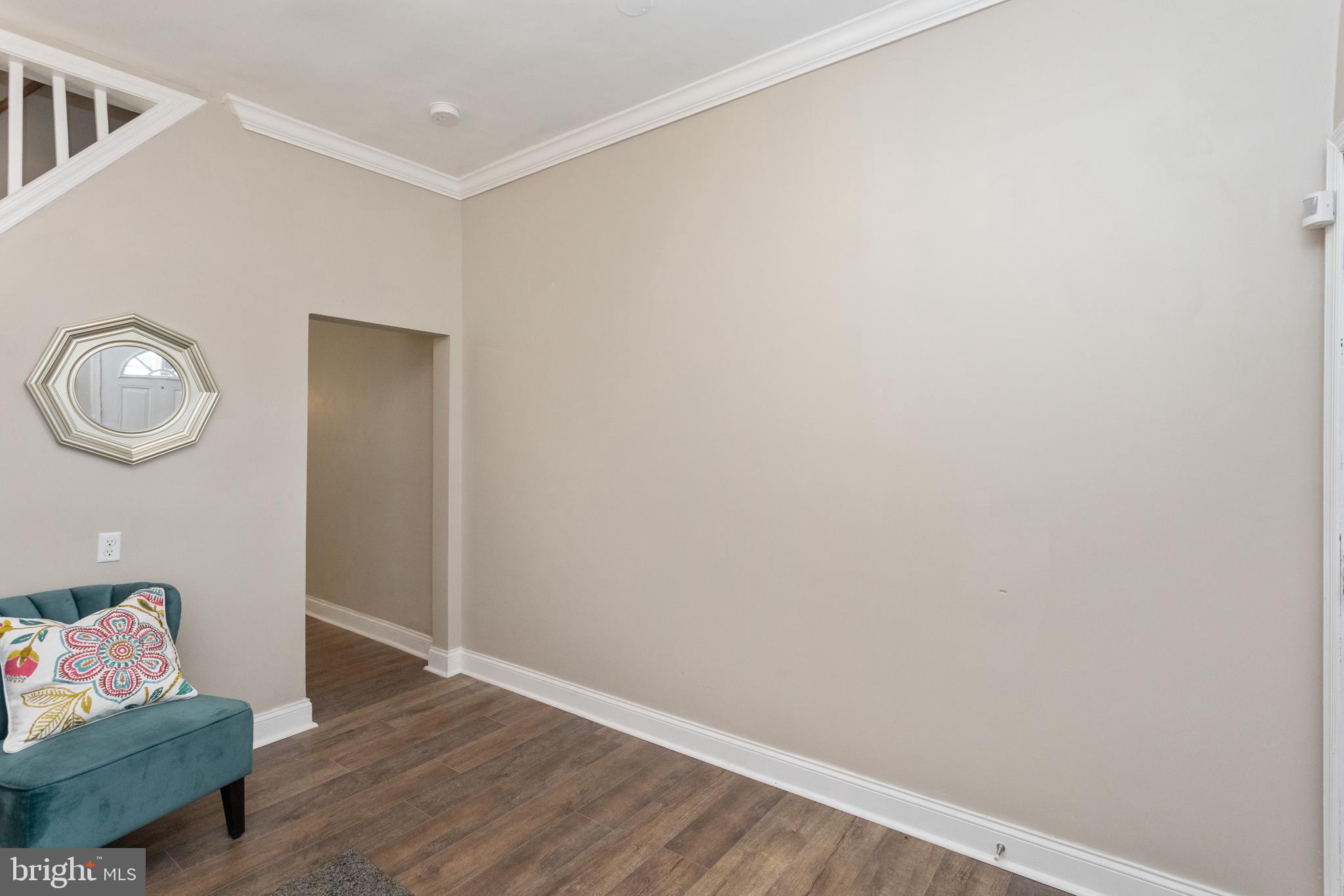 3988 Roland Avenue Baltimore, MD 21211 - Photo 8 of 31 a room with wooden floor and mirror