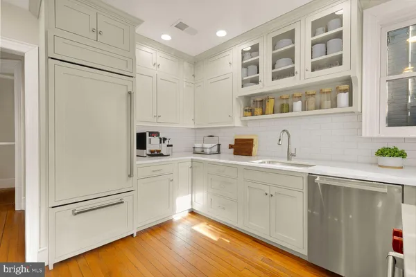 a kitchen with a refrigerator and cabinets