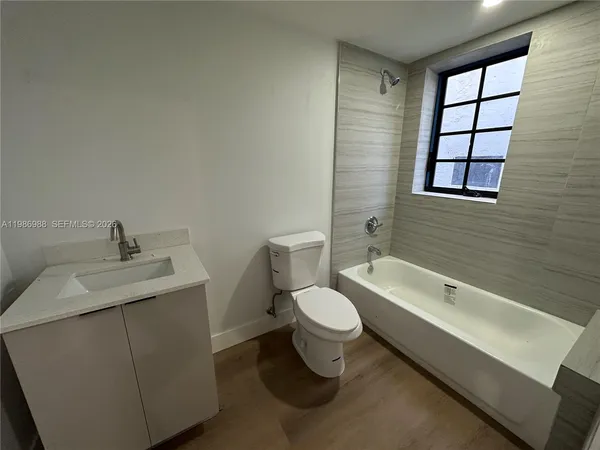 a bathroom with a sink toilet a mirror and shower