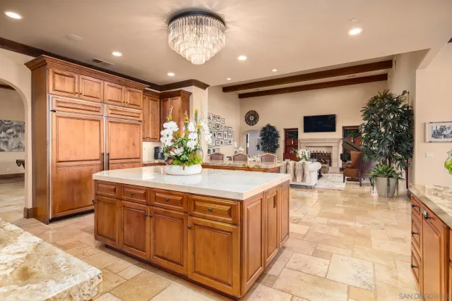 a kitchen with stainless steel appliances granite countertop a sink and a refrigerator