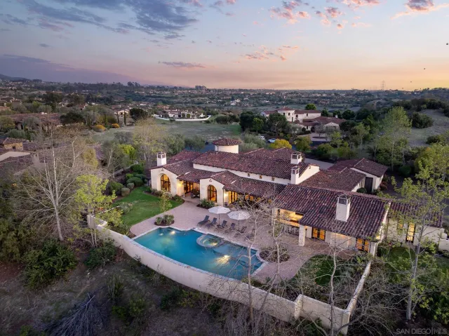 an aerial view of residential houses with outdoor space and river