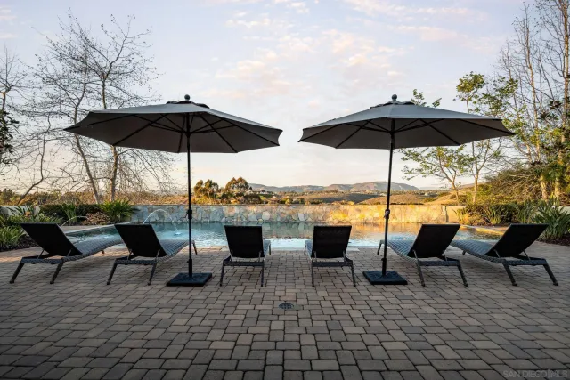 a view of an outdoor space with furniture and umbrella