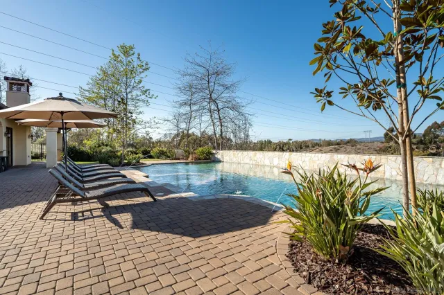 a view of a lake with a table and chairs under an umbrella