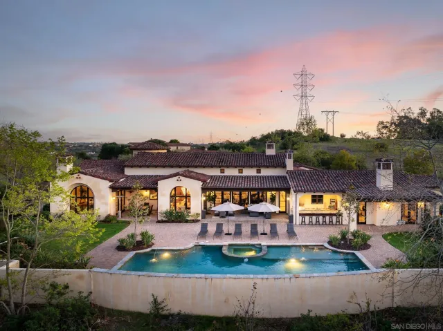 an aerial view of a house with a garden and lake view