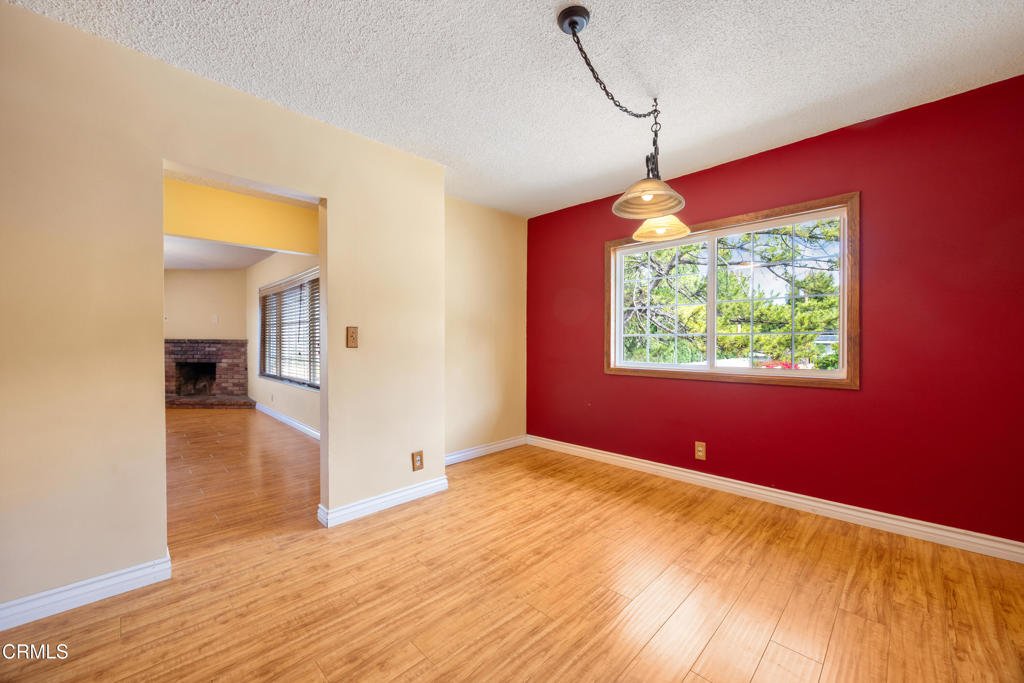 6940 Bellclaire Street Tujunga, CA 91042 - Photo 11 of 47 an empty room with wooden floor and windows
