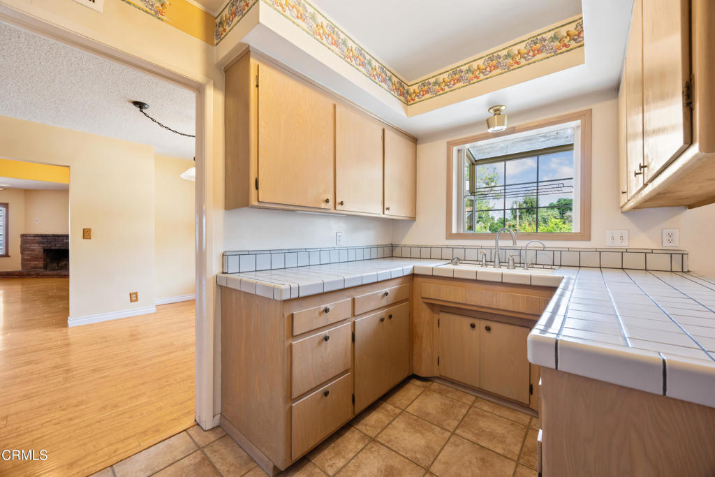 6940 Bellclaire Street Tujunga, CA 91042 - Photo 14 of 47 a kitchen that has a sink and a stove in it