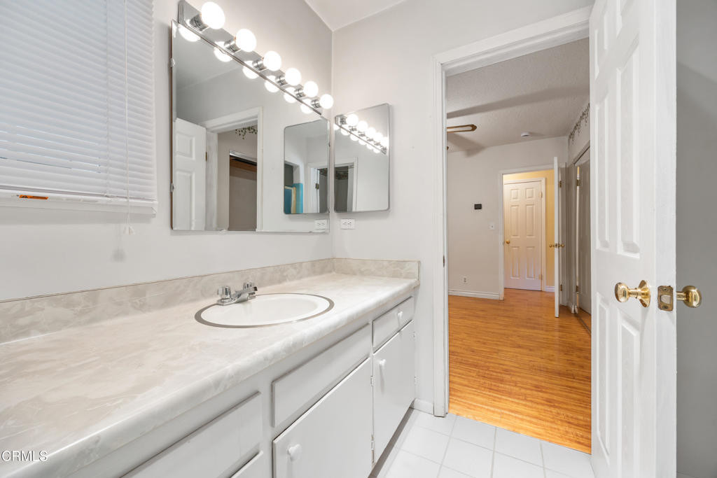 6940 Bellclaire Street Tujunga, CA 91042 - Photo 19 of 47 a bathroom with a sink and a mirror