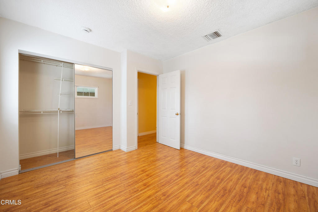 6940 Bellclaire Street Tujunga, CA 91042 - Photo 22 of 47 a view of empty room with wooden floor