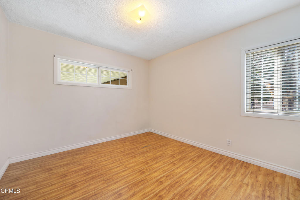 6940 Bellclaire Street Tujunga, CA 91042 - Photo 23 of 47 a view of a room with wooden floor and a window