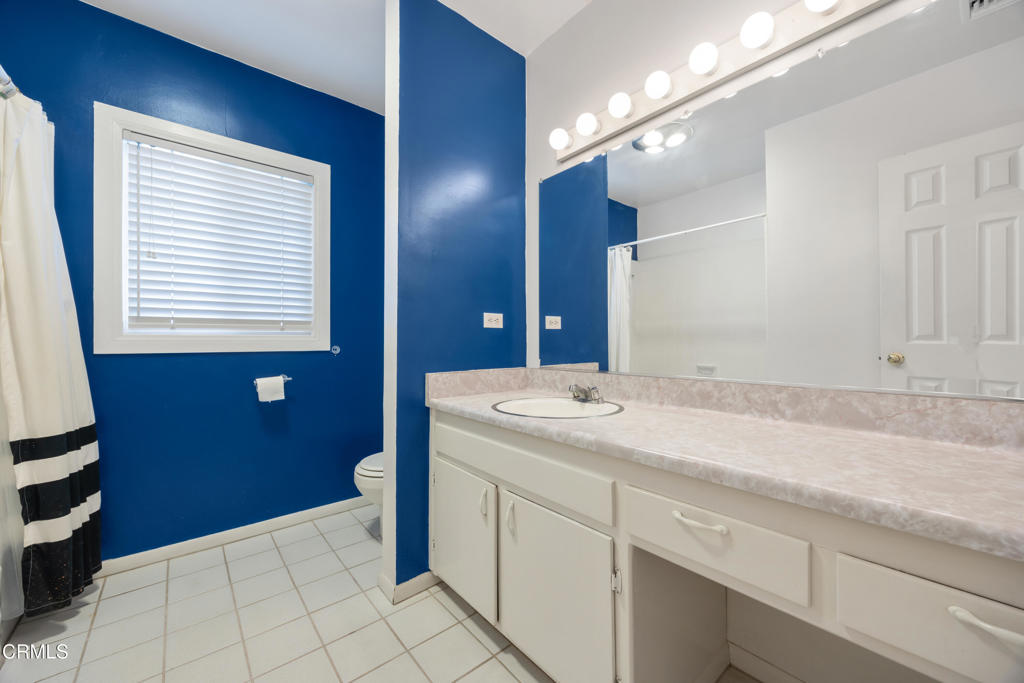 6940 Bellclaire Street Tujunga, CA 91042 - Photo 25 of 47 a bathroom with a sink a vanity and a mirror