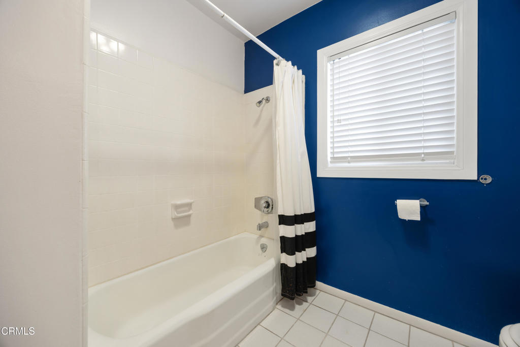 6940 Bellclaire Street Tujunga, CA 91042 - Photo 26 of 47 a bathroom with a bathtub and a shower