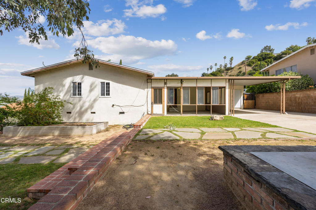 6940 Bellclaire Street Tujunga, CA 91042 - Photo 28 of 47 a view of a house with a yard and potted plants