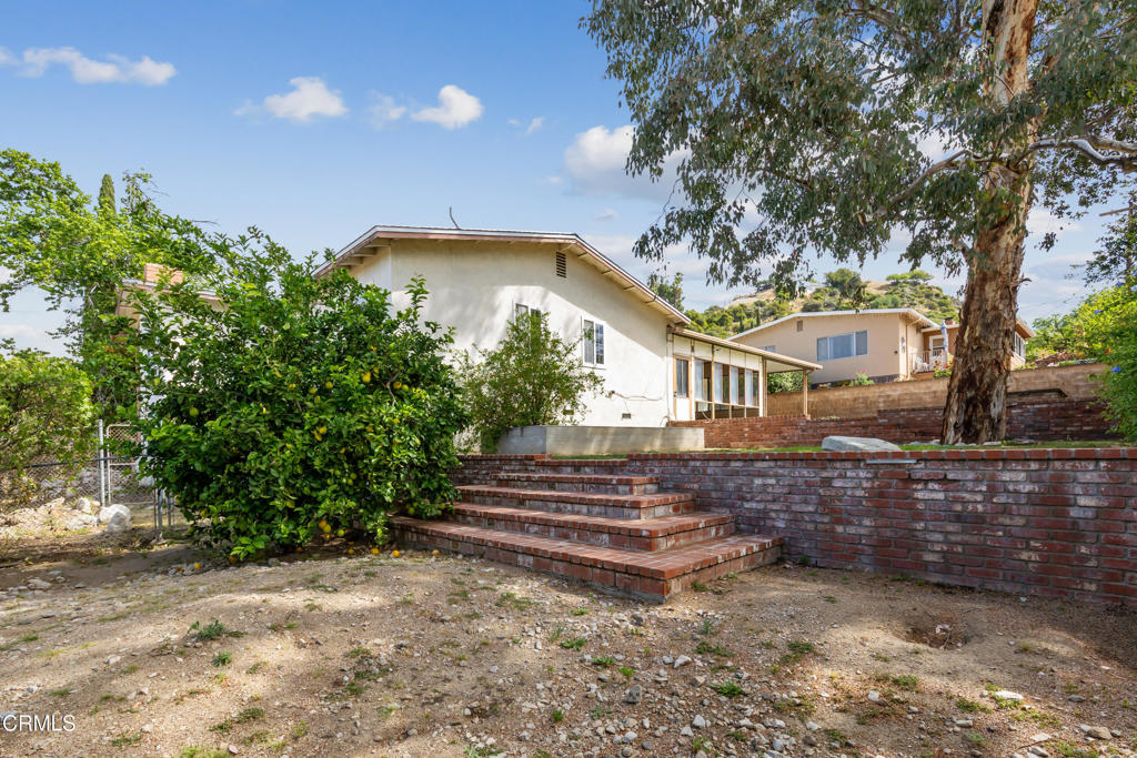 6940 Bellclaire Street Tujunga, CA 91042 - Photo 31 of 47 a front view of a house with a yard