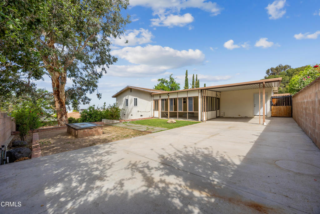 6940 Bellclaire Street Tujunga, CA 91042 - Photo 32 of 47 a view of a house with a yard and potted plants