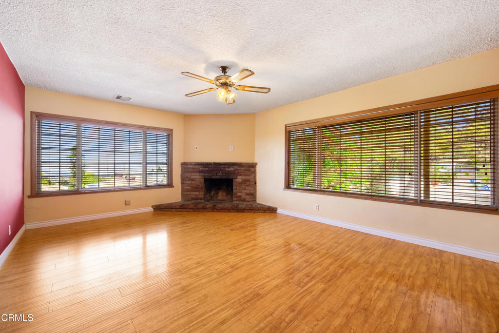 6940 Bellclaire Street Tujunga, CA 91042 - Photo 7 of 47 a view of an empty room with a window and wooden floor