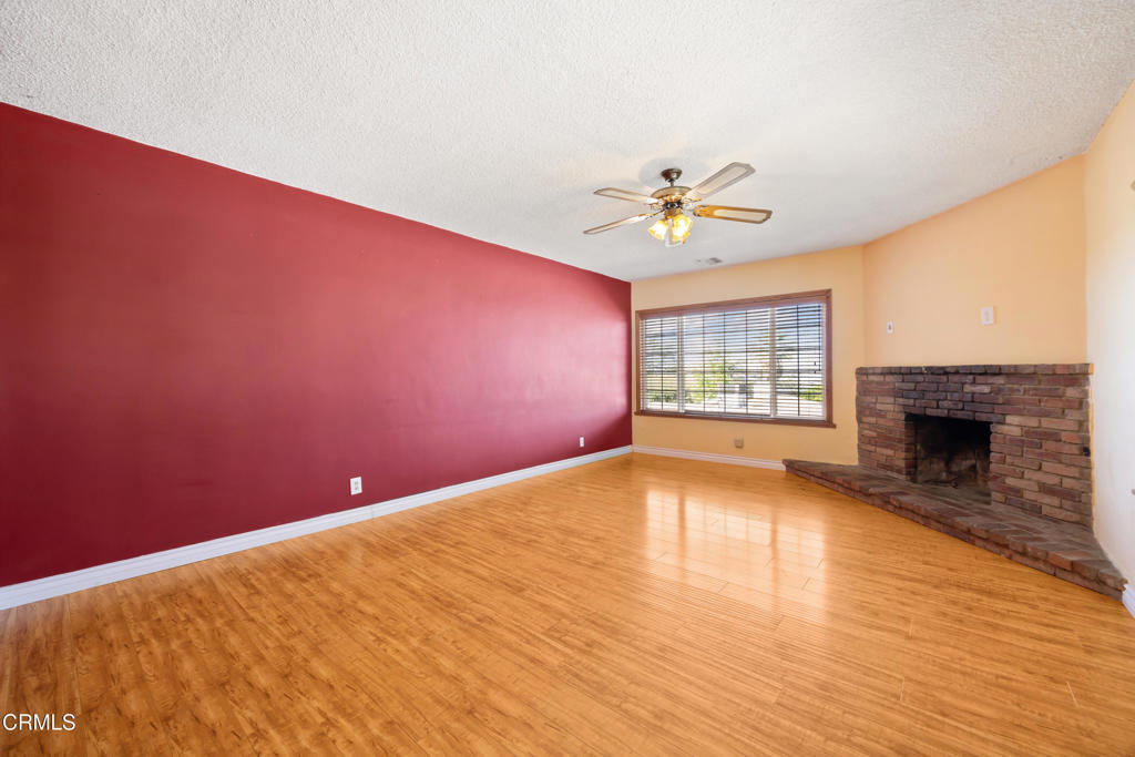 6940 Bellclaire Street Tujunga, CA 91042 - Photo 9 of 47 wooden floor in an empty room with a window