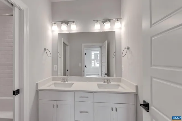 a bathroom with a sink double vanity and a mirror