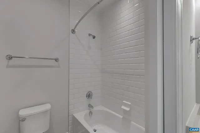 a bathroom with a bathtub and toilet