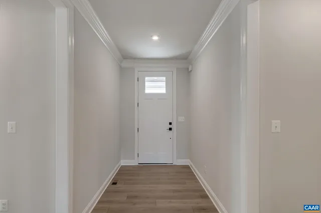 a view of a hallway with wooden floor