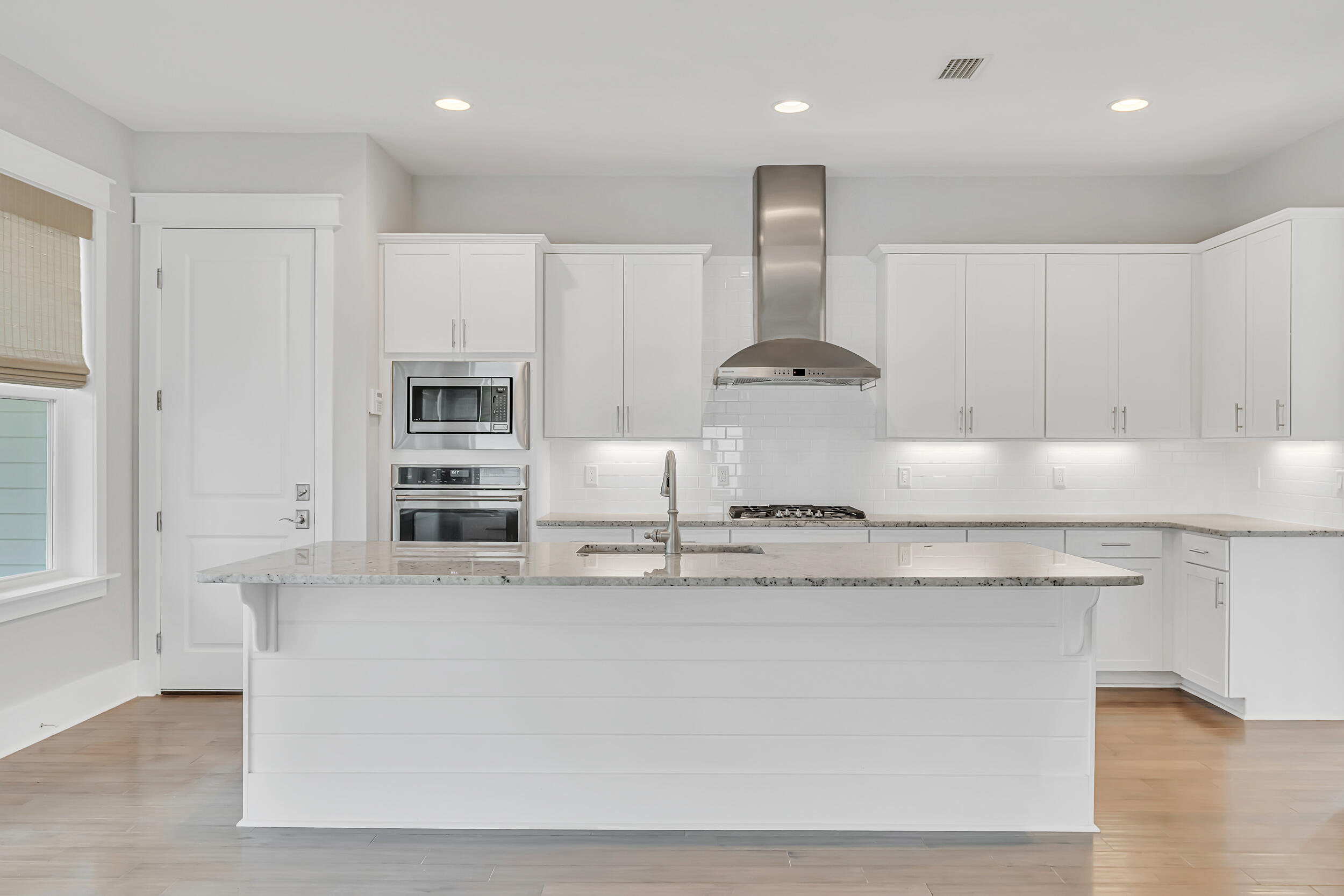 345 Flatwoods Forest Loop Santa Rosa Beach, FL 32459 - Photo 15 of 62 a kitchen with kitchen island stainless steel appliances a sink a stove a refrigerator cabinets and a counter top space
