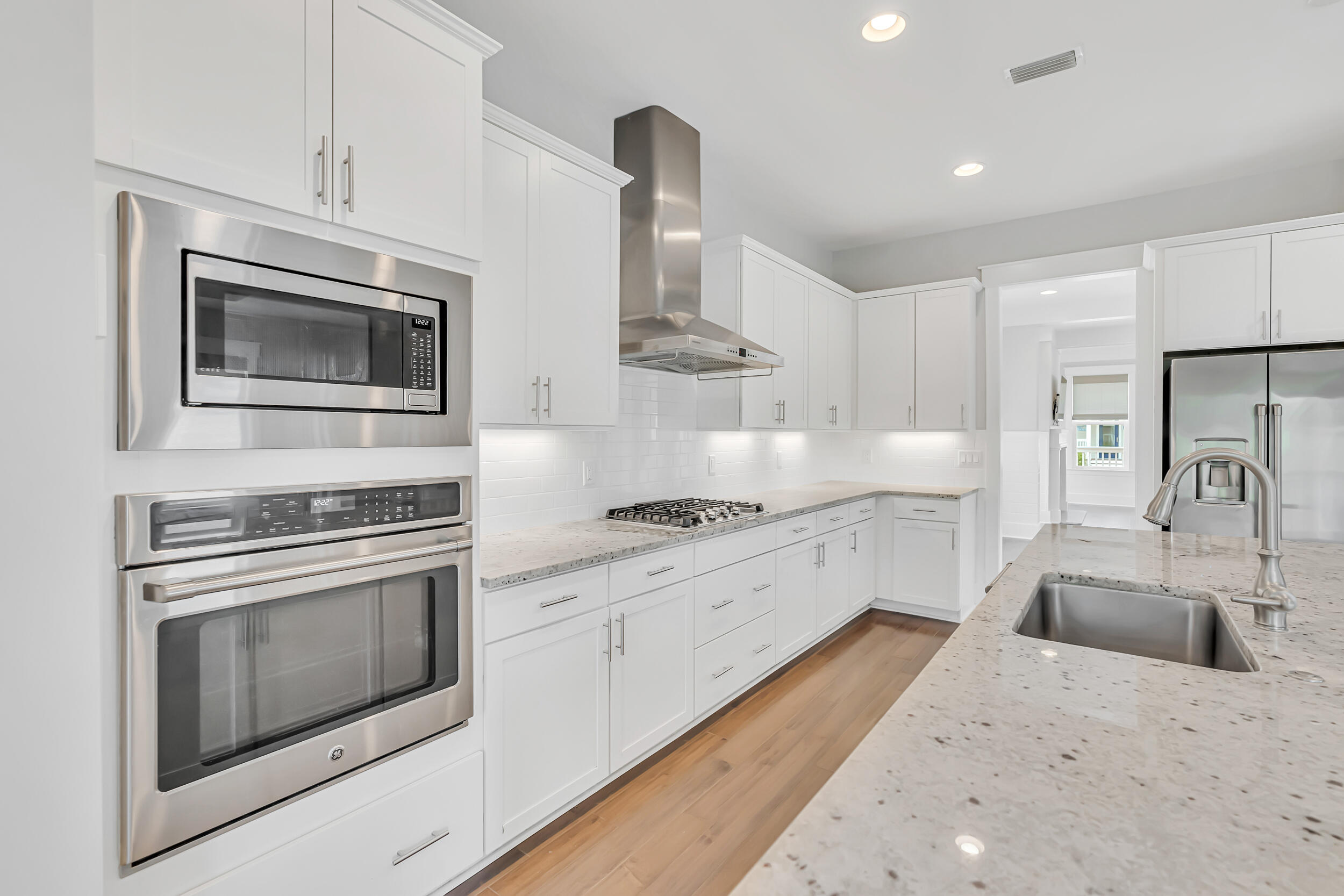345 Flatwoods Forest Loop Santa Rosa Beach, FL 32459 - Photo 18 of 62 a kitchen with granite countertop white cabinets stainless steel appliances and sink