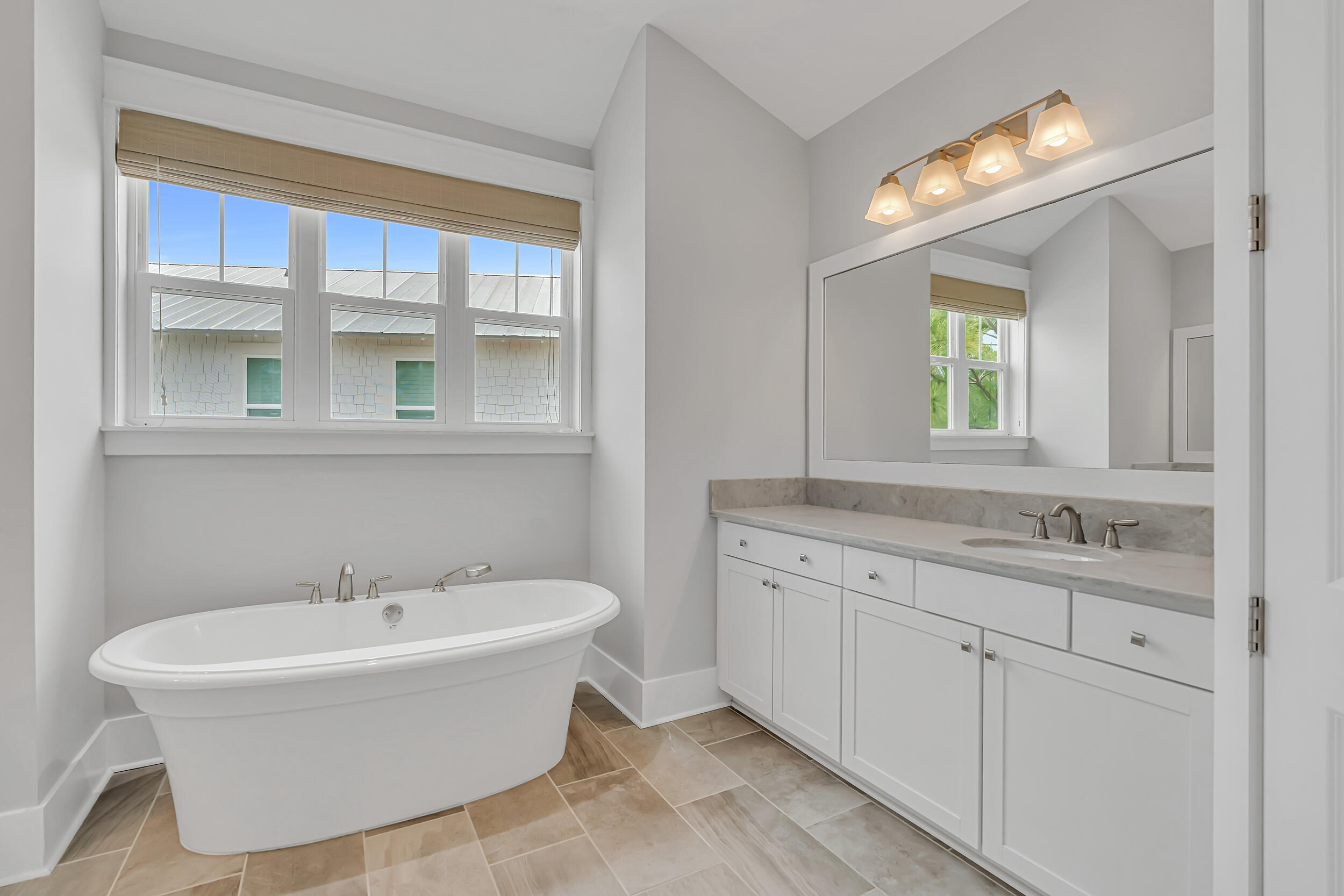 345 Flatwoods Forest Loop Santa Rosa Beach, FL 32459 - Photo 26 of 62 a white bath tub sitting next to a bathroom sink